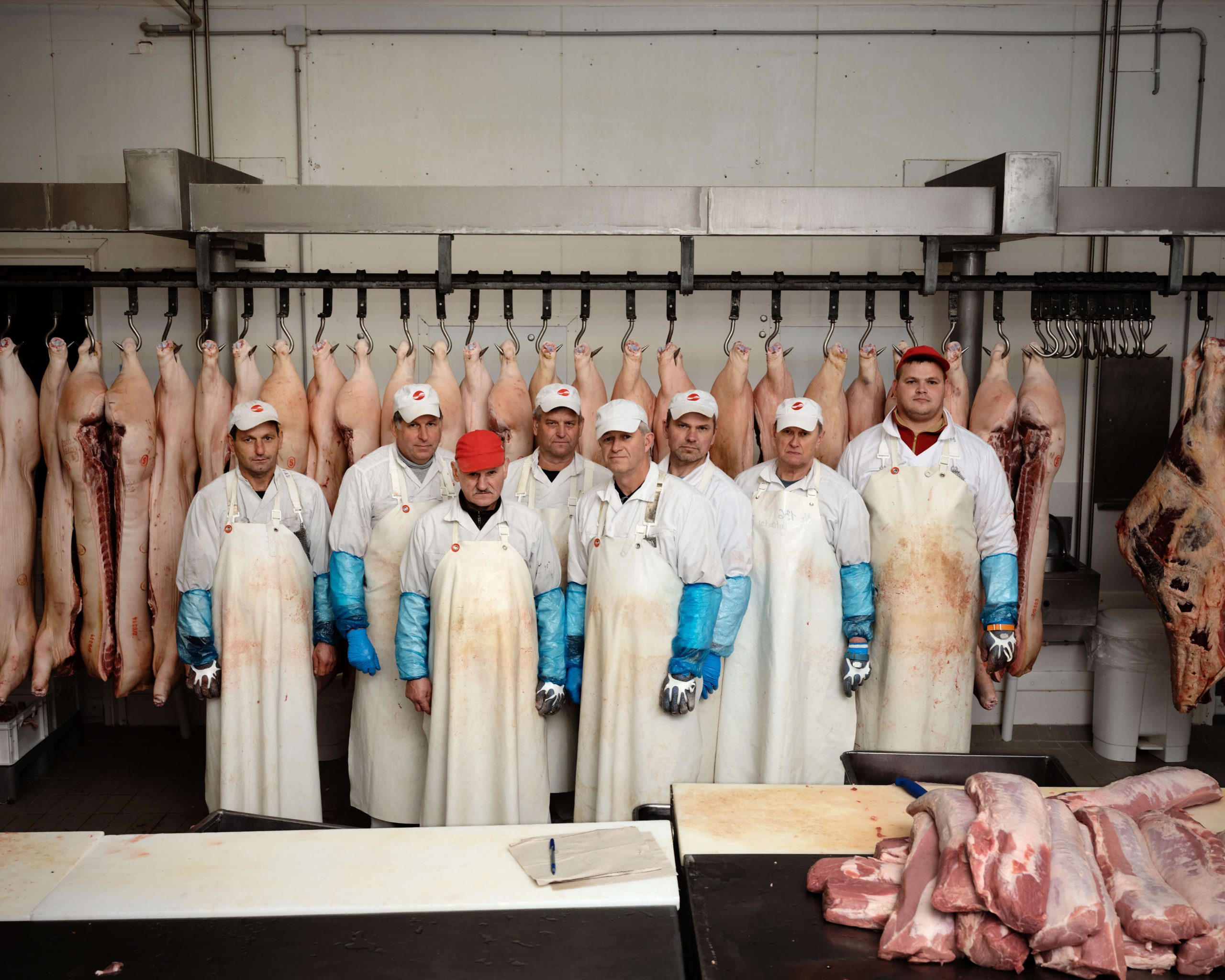 THE EUROPEANS - Arnold van Bruggen & Rob Hornstra the south west collective of photography ltd butchers stood with meat on hanging racks